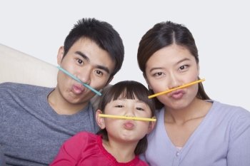 Portrait of family making a face with drinking straws