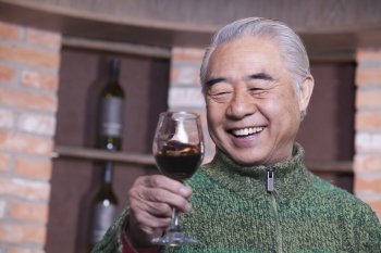 Senior Man Holding Wineglass, Portrait 