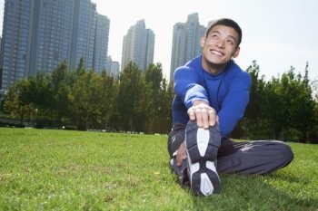 Young Athletic Man Stretching in Beijing Park- Horizontal