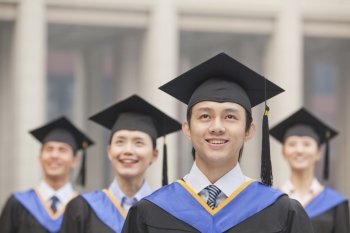  Four University Graduates Smiling, Looking Up