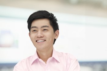 Portrait of young man in pink button down shirt, Beijing, China