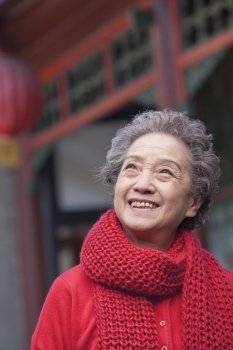 Portrait of senior woman outside a traditional Chinese building
