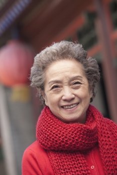 Portrait of senior woman outside a traditional Chinese building
