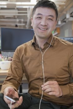 Businessman Listening Music in the Office