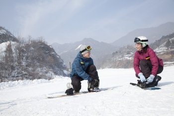 Couple adjusting Ski Boots in Ski Resort