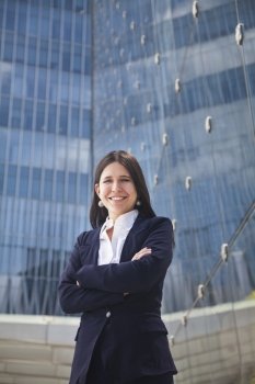 Portrait of smiling young businesswoman with arms crossed outdoors in Beijing, China