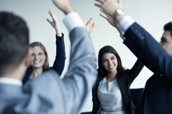 Business people cheering with arms in the air