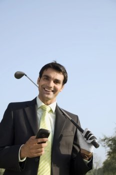 Holding a phone and a golf club 