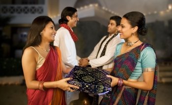 People exchanging gifts on Diwali 