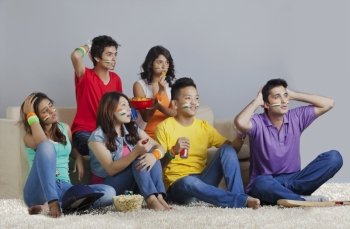 Young friends reacting with disappointment while watching cricket match 