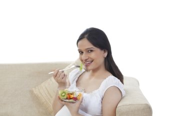 Pregnant woman eating fruits