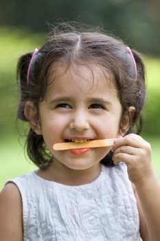 Smiling cute girl holding candy stick 