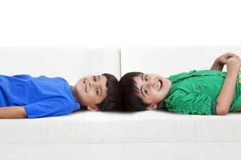 Portrait of brothers lying on sofa 