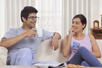 Young couple having coffee together at home 