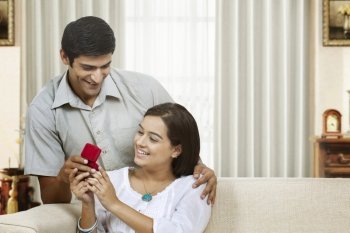 Young man presenting ring as a gift to girlfriend 