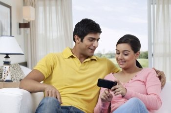 Woman showing something interesting in mobile phone 