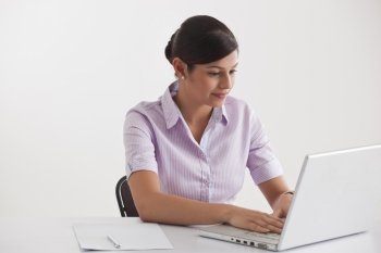 Young female executive using laptop 