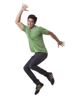 Handsome young guy jumping over white background 