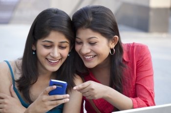 Close-up of young women using cell phone 