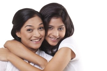Portrait of happy mother and daughter embracing 