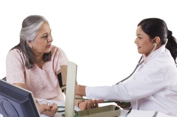 Mid adult doctor checking patient’s blood pressure 