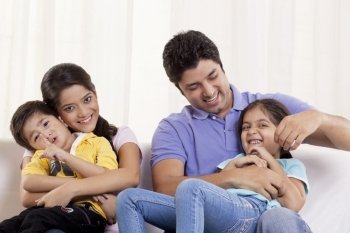 Happy family sitting on sofa 