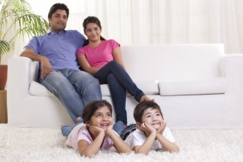 Smiling family watching TV 