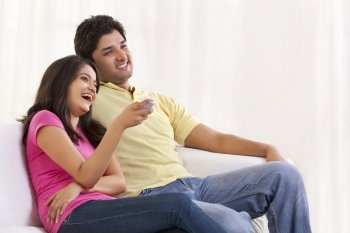 Smiling couple watching TV 