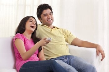 Happy couple watching TV 