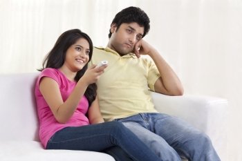 Young woman sitting with bored husband 
