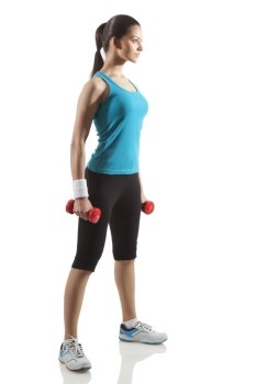 Fit young woman exercising with dumbbells isolated over white background