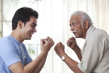 Grandfather boxing with grandson