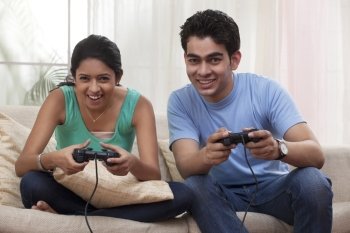 Brother and sister playing video game