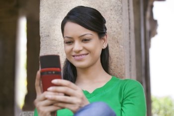 Woman smiling while reading an sms