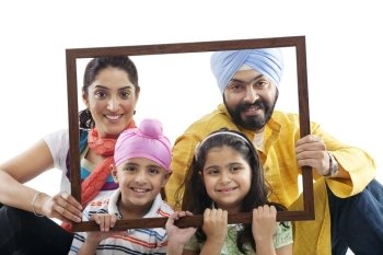 Portrait of a Sikh family through a wooden frame 