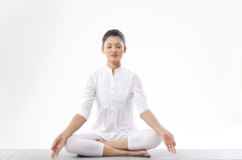 Woman meditating over white background 