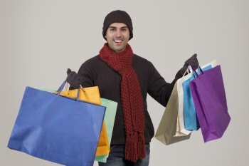 Portrait of young man holding shopping bags 