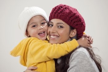 Portrait of smiling mother and son embracing 