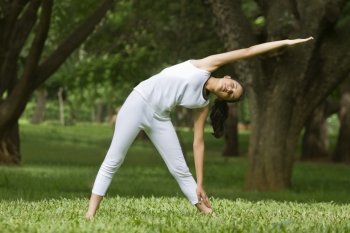 Young woman exercising in a park 