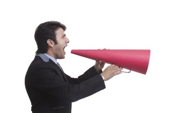 Businessman screaming on paper megaphone