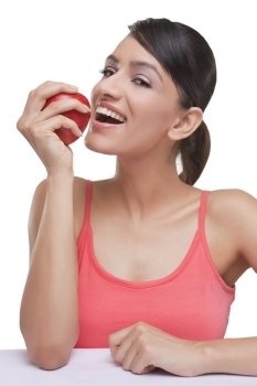 Portrait of smiling young woman with fresh apple over white background 