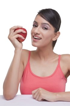 Portrait of beautiful woman with fresh apple over white background 