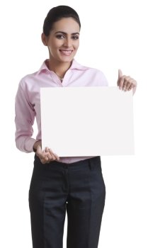Portrait of happy young businesswoman showing blank board over white background
