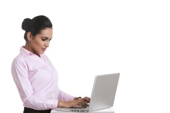 Young Indian businesswoman using laptop over white background