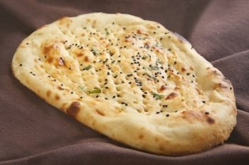 Close-up of naan topped with sesame seeds