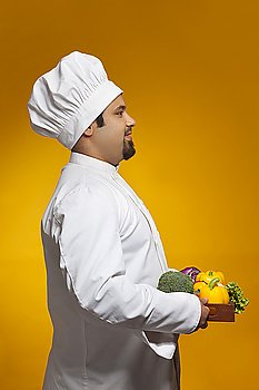 Chef with tray of vegetables