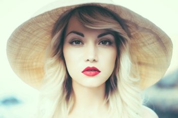 Portrait of a beautiful young lady in a straw hat