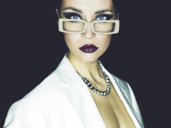 Fashion studio portrait of beautiful woman with glasses