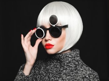 Fashion studio photo of beautiful stylish lady in sunglasses