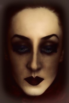 face of young woman with bright gothic makeup closeup